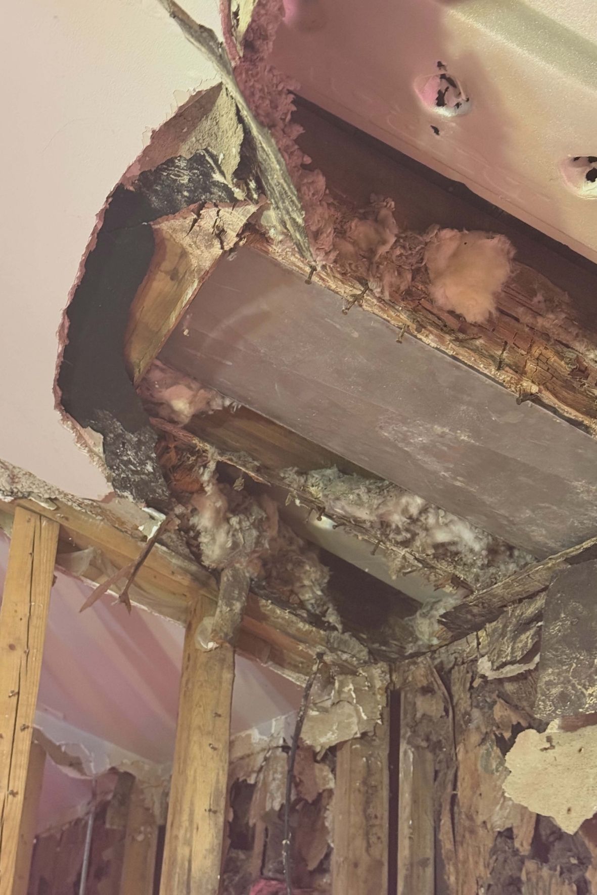 Charpente murale et plafond partiellement ouverts avec isolant apparent dans une maison  à Lachute